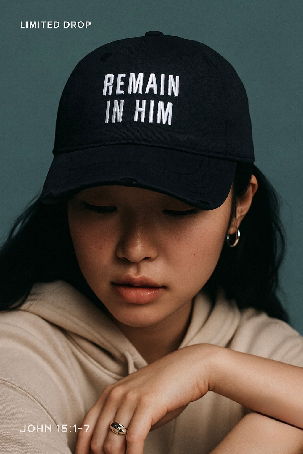 Person wearing a black cap with 'REMAIN IN HIM' text on a dark background